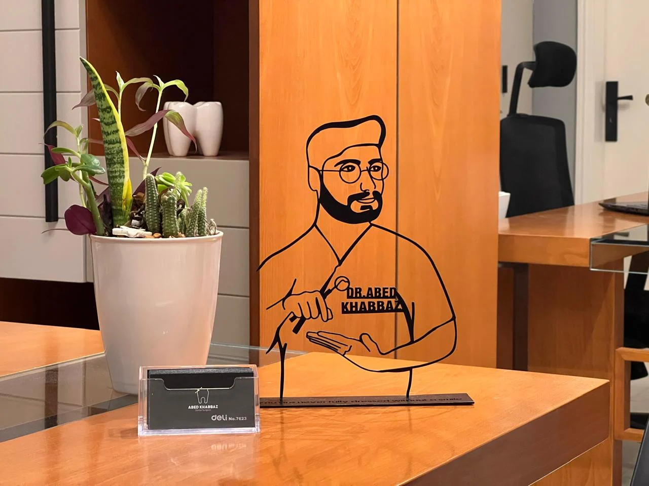 A personalised dentist illustration beside plants at the clinic