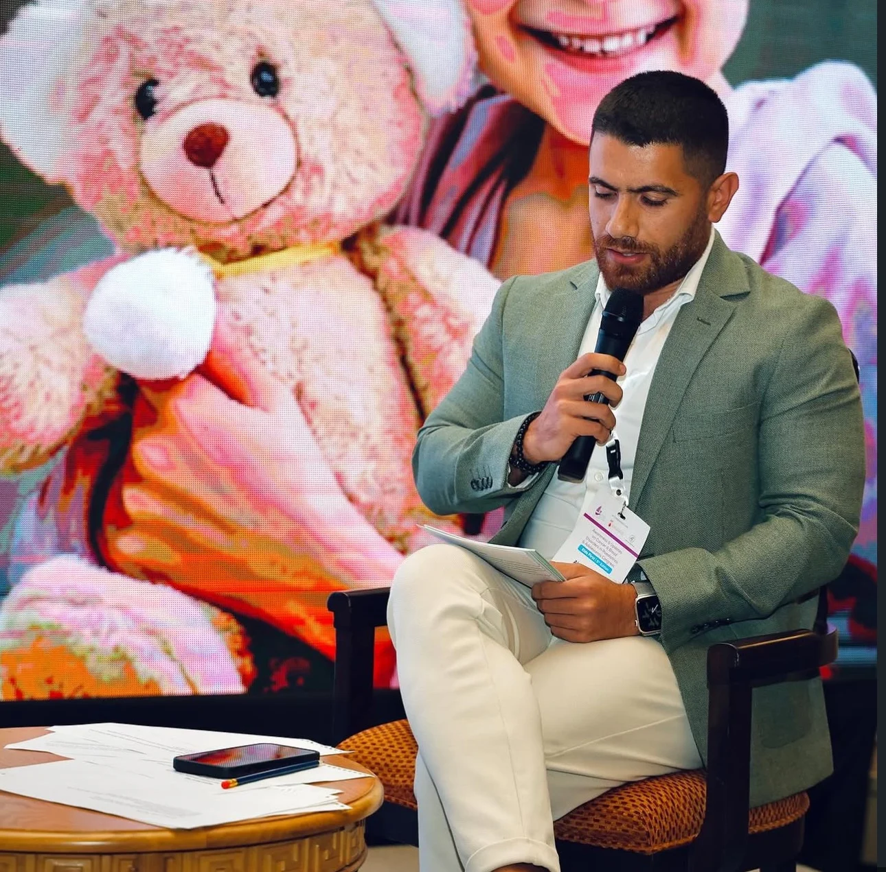 Dr. Abed Khabbaz speaking with a microphone during a medical panel